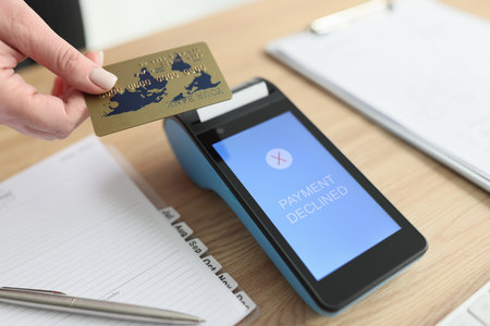 Woman puts card to terminal trying to pay for servicesの写真素材