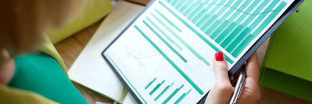 Woman accountant using laptop and making financial report