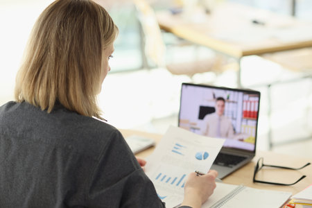 Manager talks to partner on video call via modern laptop