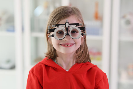 Girl wears goggles for eyesight correction looking in cameraの写真素材