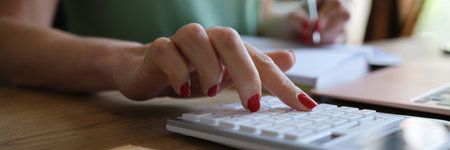 Woman doing calculation of expenses and income and making notesの写真素材