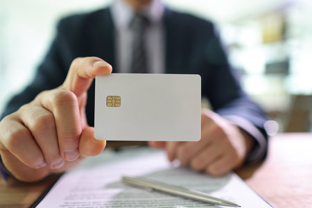 Successful businessman holds white credit card in handの写真素材