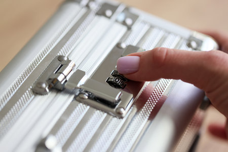 Hand of woman closing silver case with electronic equipment