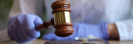 Female doctor with judge gavel and medical stethoscopeの写真素材