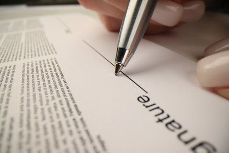 Businesswoman prepares to sign contract showing agreementの写真素材