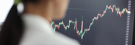 Happy woman trader working on pc and making technical analysis of trendsの写真素材