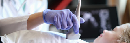 Practitioner doing diagnostic examination of childs heart using ultrasound machineの写真素材