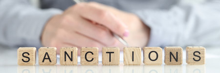 Sanctions word collected with wooden cubes in rowの写真素材