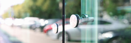 Stainless steel handle on glass door closeupの写真素材