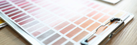 Samples of color catalog and different shades of colors on office table