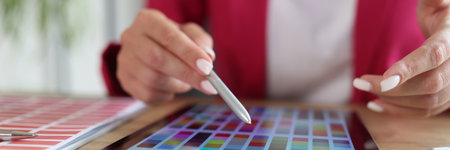 Woman working with color swatches for selection on tabletの写真素材
