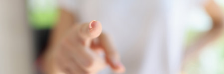Female hand pointing at camera with fingerの写真素材