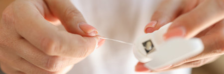 Female hands holding teeth cleaning thread or dental floss