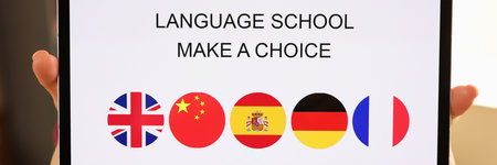 Female hands holding tablet with open language school applicationの写真素材