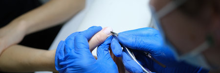 Manicurist makes manicure to client in beauty salon.の写真素材