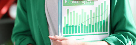 Female financial manager holding clipboard with attached documents.
