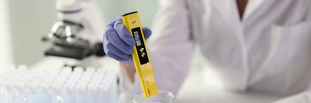Close-up of female scientist conducting tests in laboratory.