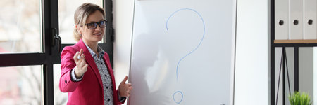 A happy woman in the office stands a white board, close-up