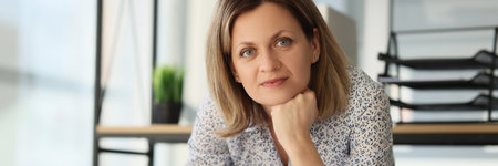 A young woman with a pencil and whatman on the tableの写真素材