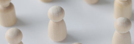 Female and male wooden figures are scattered on white background.の写真素材