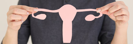 Woman holding symbol of fight against female infertilityの写真素材