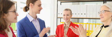 Happy colleagues clap hands after finishing joint projectの写真素材