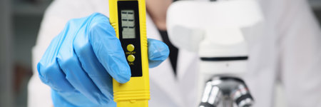 Female scientist examines soil in container with cannabisの写真素材