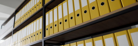 Yellow ring binders with files put in long rows on shelvesの写真素材