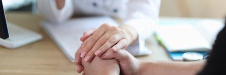 Doctor supports patient after revealing severe diagnosisの写真素材