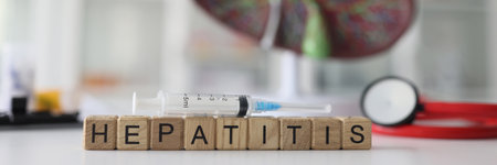 Word Hepatitis made of wooden blocks with syringe on topの写真素材