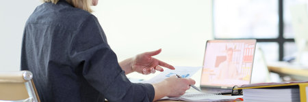 Woman discusses statistic data with colleague on video call