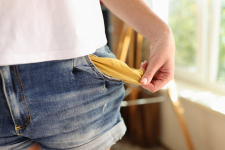 Close up of woman showing her empty pocket.の写真素材