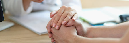 Female doctor hand holding patient empathy, support and compassionの写真素材