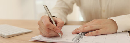 Woman planning business and taking notes in officeの写真素材