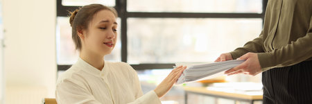 Employee giving pack of documents to manager, extra work for executorの写真素材
