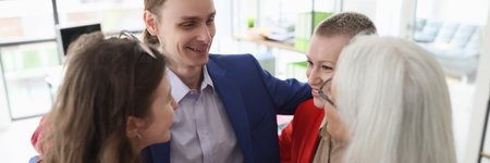 Corporate employees hug to support and inspire in officeの写真素材