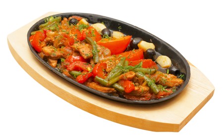 Roastpig with vegetables on carving boardの写真素材