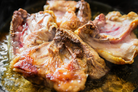 Chicken with spice on frying panの写真素材
