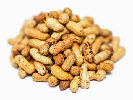 Pile of dried peanuts on white backgroundの写真素材