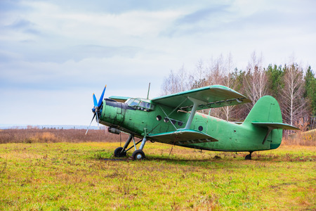 Old airplane on field in autumn time