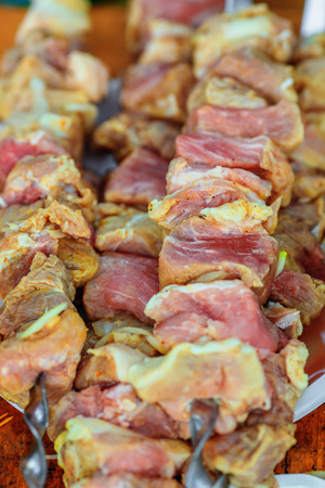 Raw meat on skewers prepared for grilling on the barbequeの写真素材