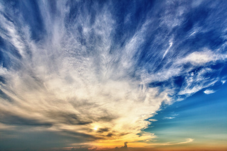 Background of blue sky with fleecy clouds (sunset time)の写真素材