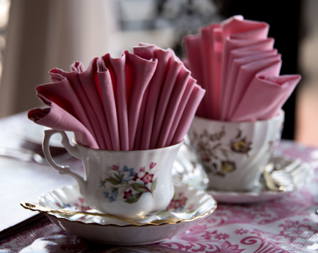 Two china tea cups with pink napkinsの写真素材