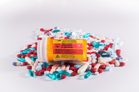 Pill bottle with label warning of side effects including dizziness and drowsinessの写真素材