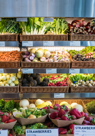 Colorful display of fresh fruits and vegetables at a local marketの写真素材
