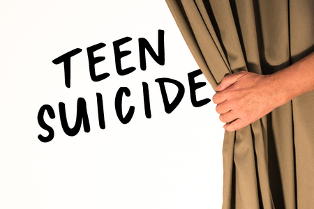 The words Teen Suicide being revealed from behind a curtainの写真素材