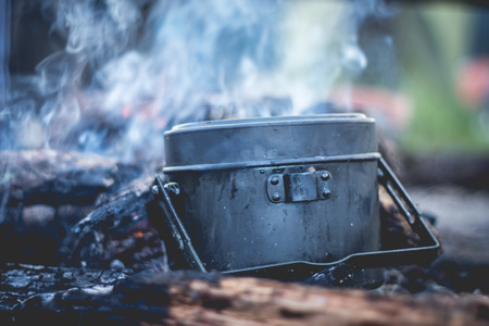 Cooking army pot on bonfireの写真素材