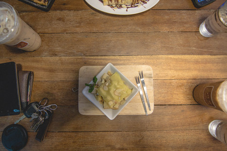 Toast topped with nuts peppermint and cheese in a dish on the dining tableの写真素材