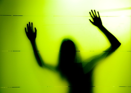 Young woman behind the matte glassの写真素材