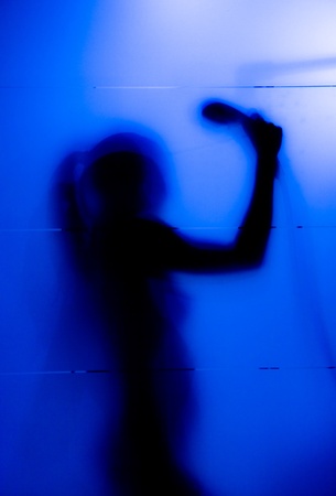 Young woman behind the matte glassの写真素材